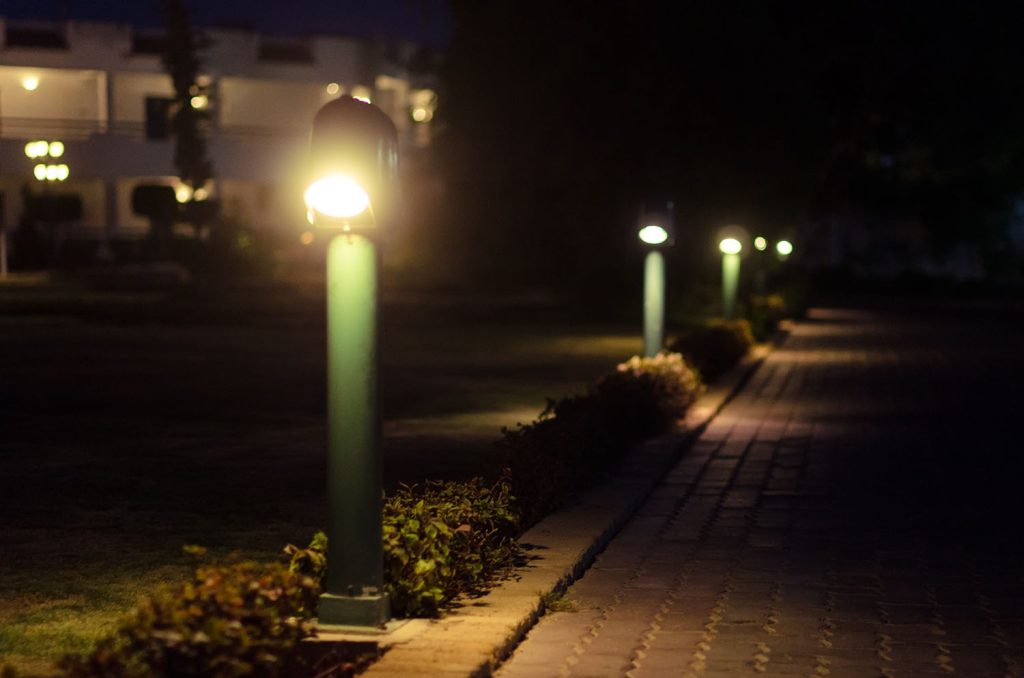 Outdoor lighting installation as part of commercial landscaping, improving business safety.